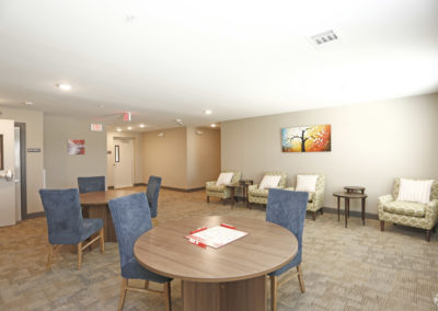 Community room at The Villages at Fiskville with tables and chairs